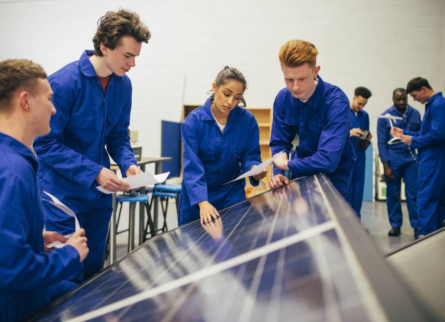 People wearing blue clothes learning about solar panels